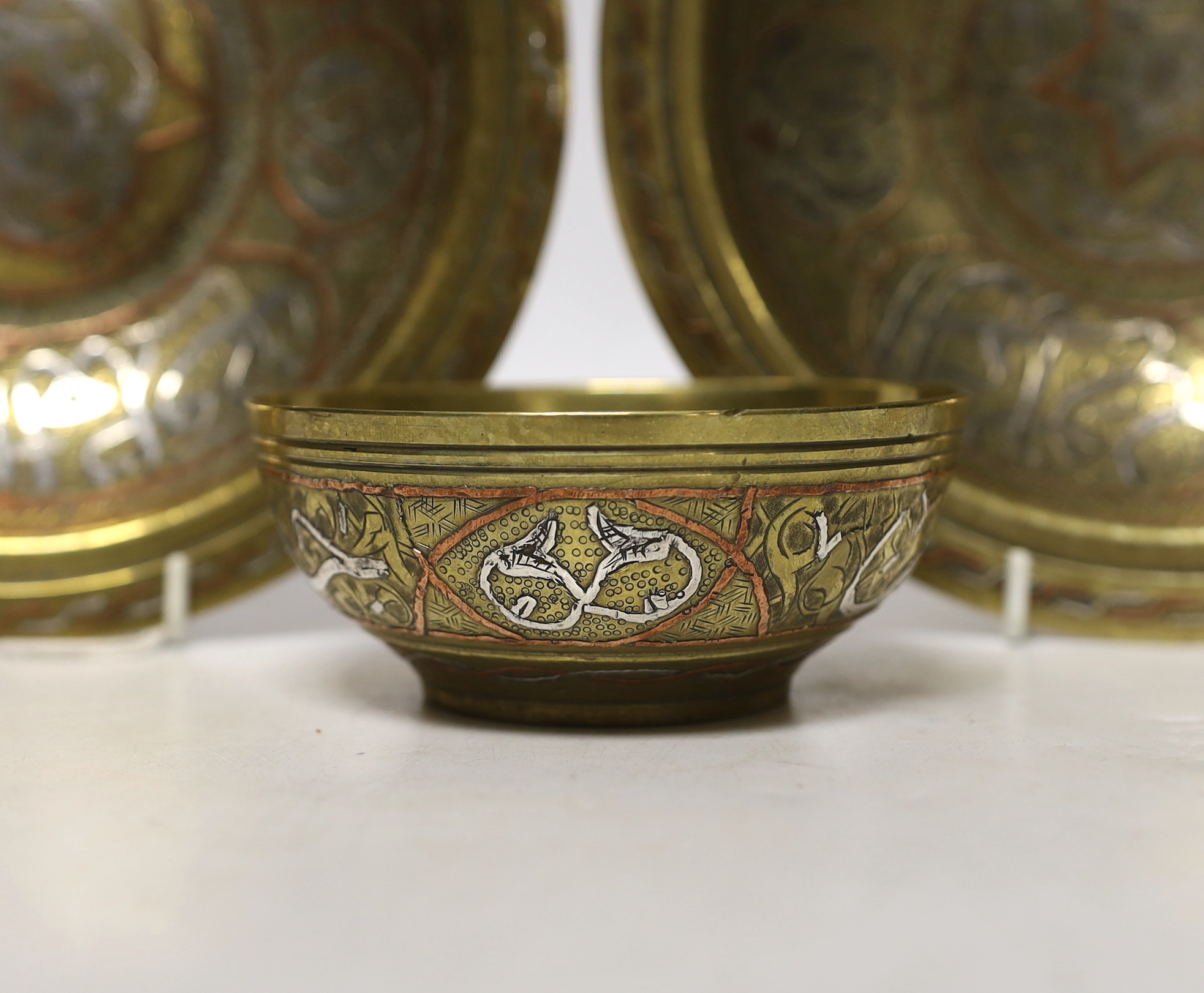A pair and another inlaid brass dishes, Cairo ware, largest 19cm
